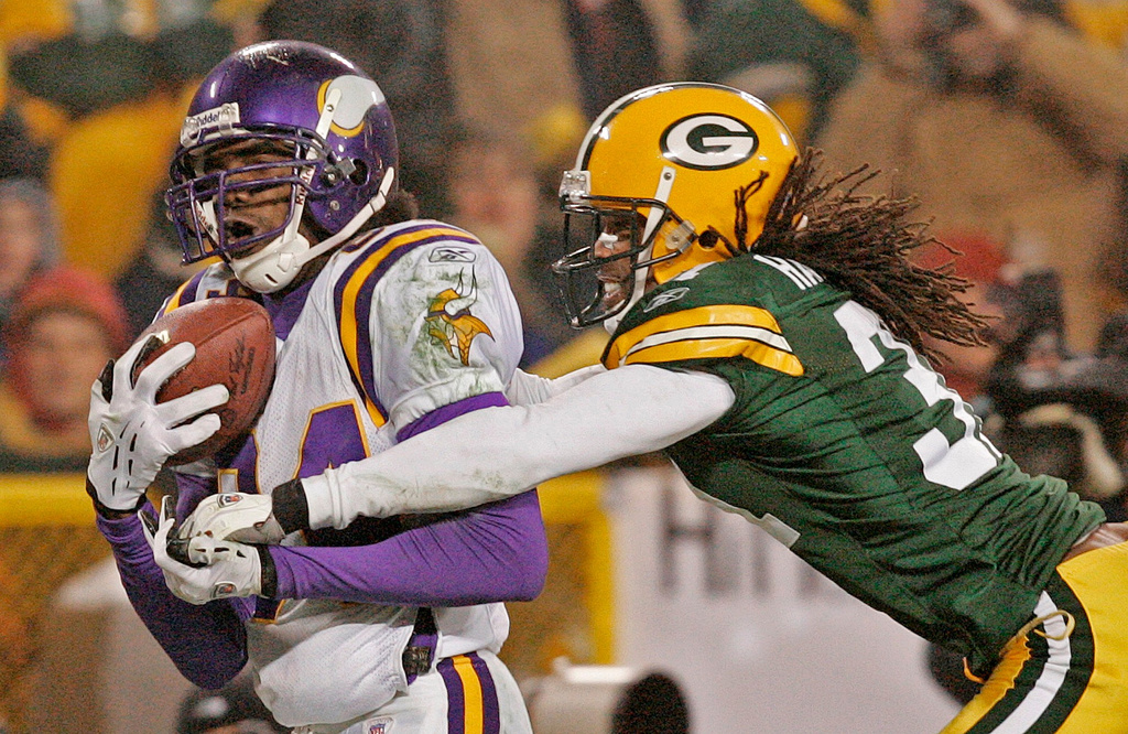 FILE - Minnesota Vikings receiver Randy Moss catches a 34-yard touchdown pass in front of Green Bay Packers cornerback Al Harris in the fourth quarter of their NFC wild-card game Sunday, Jan. 9, 2005, in Green Bay, Wis. (AP Photo/Andy Manis, File)