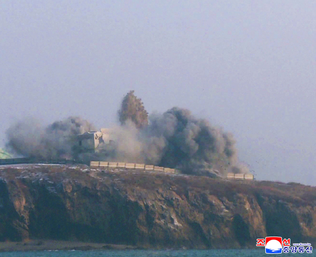 In this photo provided by the North Korean government, smoke billows from a building after it says a long-range strategic cruise missile fired from the Yellow Sea off North Korea hit Sunday, Dec. 28, 2025. Independent journalists were not given access to cover the event depicted in this image distributed by the North Korean government. The content of this image is as provided and cannot be independently verified. Korean language watermark on image as provided by source reads: "KCNA" which is the abbreviation for Korean Central News Agency. (Korean Central News Agency/Korea News Service via AP)