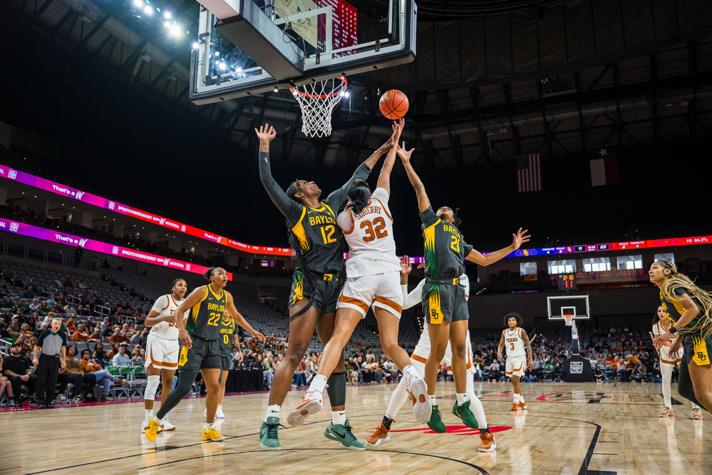 Baylor forward Kyla Abraham (12), Texas forward Teya Sidberry (32,) and Baylor guard Marcayla Johnson (21) contest a rebound during an NCAA college basketball game, Sunday, Dec. 14, 2025, Fort Worth, Texas. (AP Photo/Jessica Tobias)