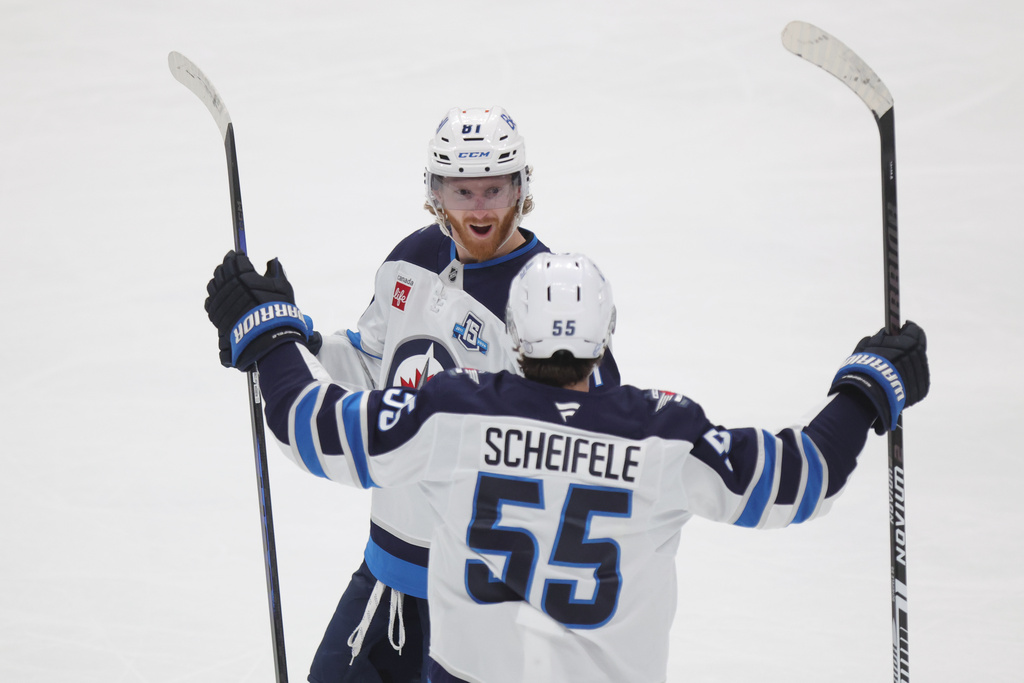 Winnipeg Jets forward Kyle Connor, left, celebrates with teammate forward Mark Scheifele after Conner's goal against the Columbus Blue Jackets during the third period of an NHL hockey game in Columbus, Ohio, Saturday, April 4, 2026. (AP Photo/Paul Vernon)