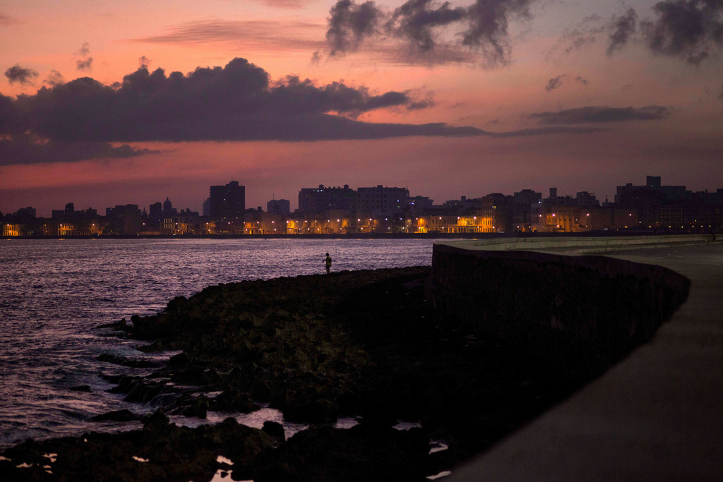 FILE - A fisherman casts his line along the Malecon at sunrise in Havana, Cuba, Wednesday, Oct. 8, 2014. (AP Photo/Ramon Espinosa, File)