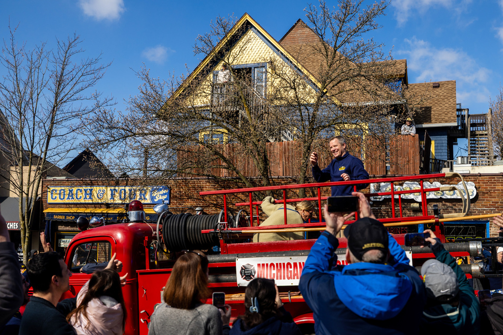 Michigan head coach Dusty May smiles during a parade celebrating their national championship win in the NCAA college basketball tournament , Saturday, April 11, 2026, in Ann Arbor, Mich. (Devin Anderson-Torrez/Ann Arbor News via AP)