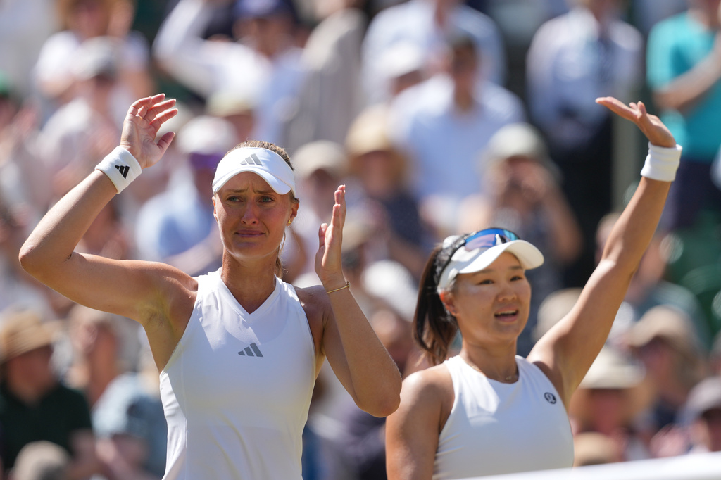 Kristina Mladenovic of France, left playing partner Hanyo Guo of China, celebrate after defeating with Luisa Stefani of Brazil and Gabriela Dabrowski of Canada, in the women's doubles final, playing against at Wimbledon Tennis Championships in London, Sunday, July 12, 2026. (AP Photo/Kin Cheung)