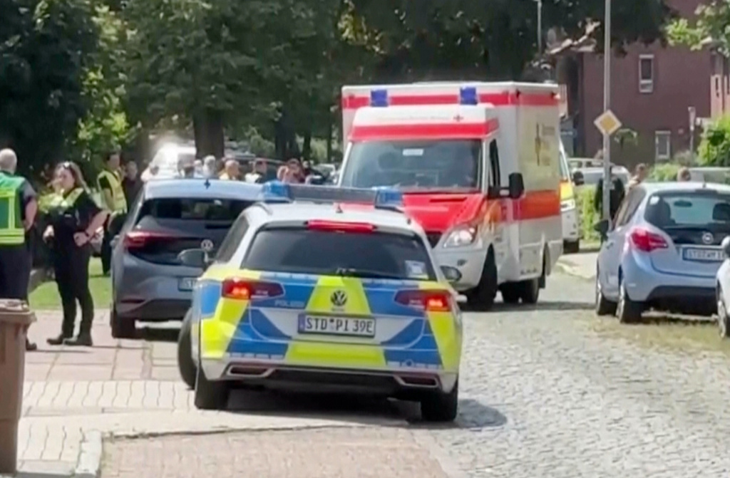 In this image taken from a video, emergency responders, residents and police in Stade, Germany, Monday, June 29, 2026 after five people were killed in a shooting on Monday at a youth welfare facility in the northern German town of Stade, police said. (NWM-TV via AP)