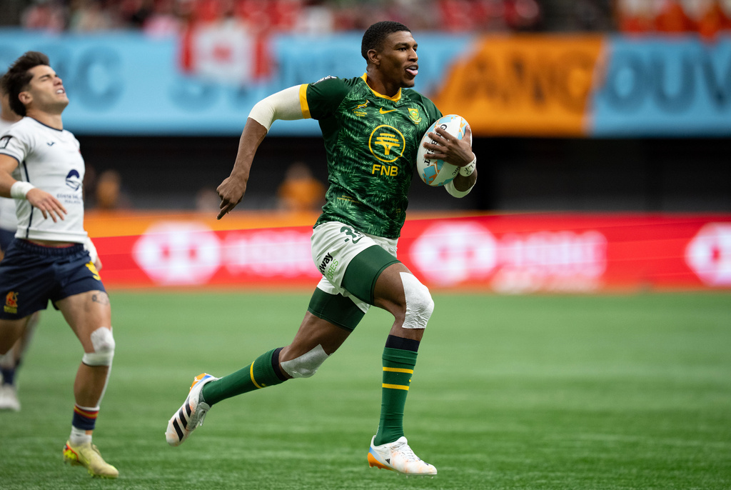 South Africa's Gino Cupido (35) runs the ball to score a try against Spain during the gold medal Vancouver Sevens rugby match, in Vancouver, British Columbia, Sunday, March 8, 2026. (Ethan Cairns/The Canadian Press via AP)