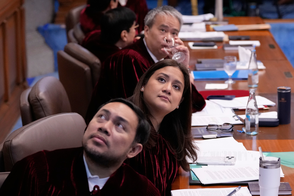 Philippine senator, from left, Mark and his sister Camille Villar and Joel Villanueva look at the projector as documents are shown during the impeachment trial of Philippine Vice President Sara Duterte at the Philippine Senate in Pasay city, Philippines on Tuesday, July 7, 2026. (AP Photo/Aaron Favila, Pool)
