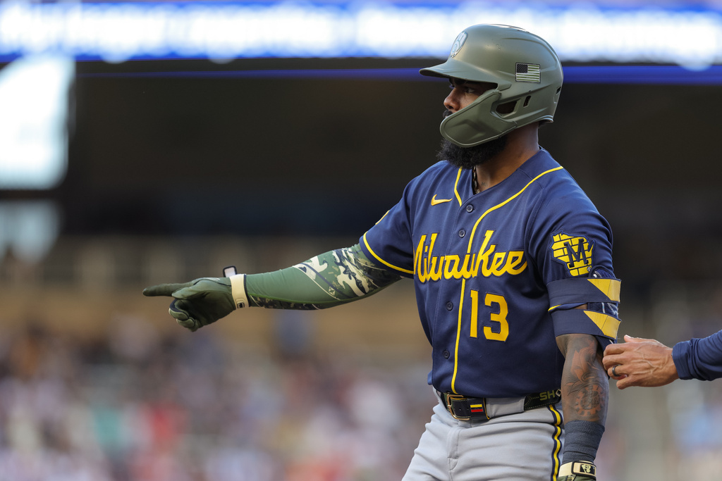 Milwaukee Brewers' Luis Rengifo celebrates after reaching first base on a fielding error by Minnesota Twins third baseman Royce Lewis during the fourth inning of a baseball game Saturday, May 16, 2026, in Minneapolis. (AP Photo/Bailey Hillesheim)
