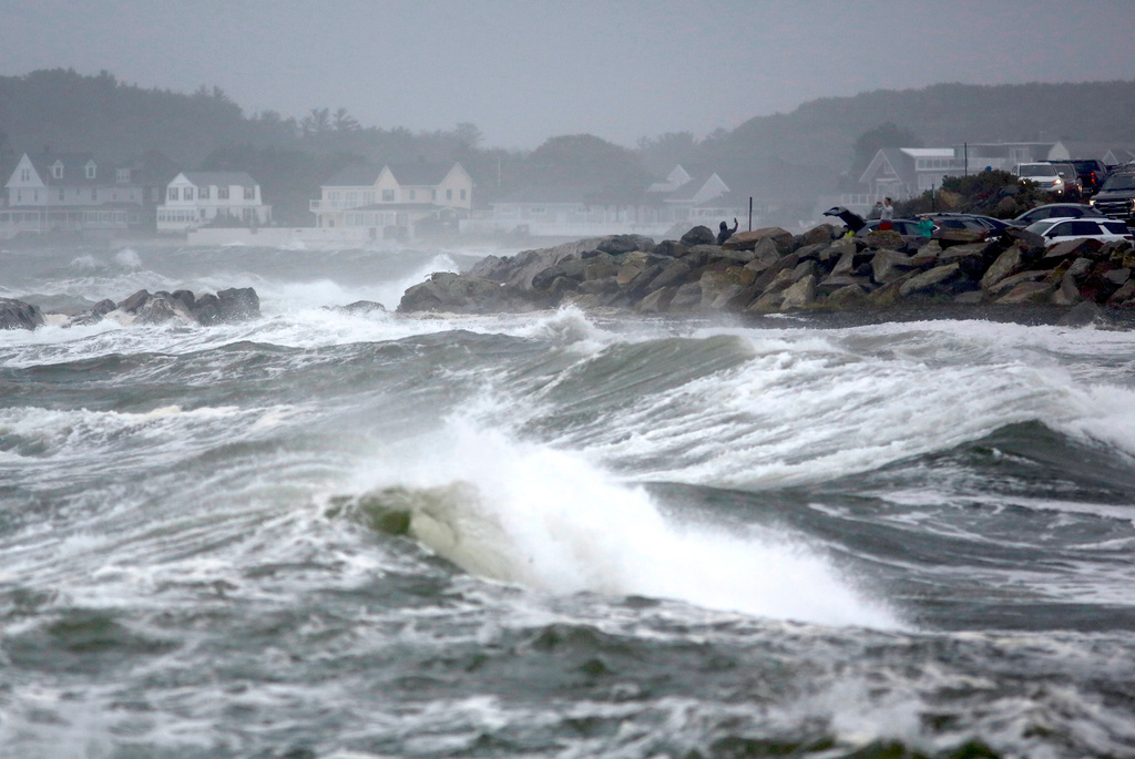 People watch the ocean as a nor'easter storm hits Rye, New Hampshire, Sunday, Sept. 27, 2026. (AP Photo/Caleb Jones)