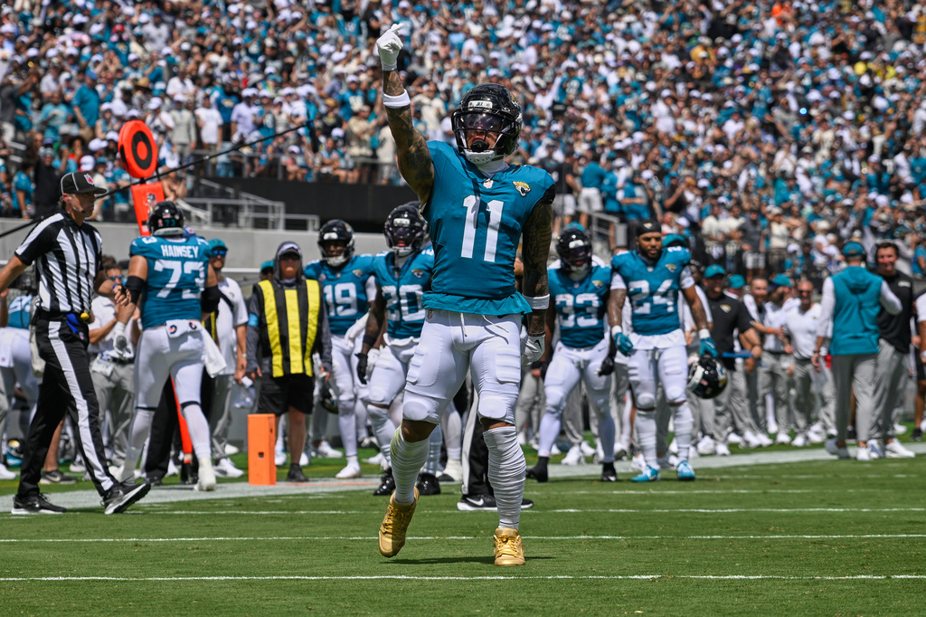 Jacksonville Jaguars wide receiver Parker Washington (11) celebrates after his touchdown catch in the first half of an NFL football game against the Cleveland Browns, Sunday, Sept. 13, 2026, in Jacksonville. (AP Photo/Phelan M. Ebenhack) CORRECTION: Corrects to Jaguars wide receiver Parker Washington (11) not Jaguars cornerback Montaric Brown (1).