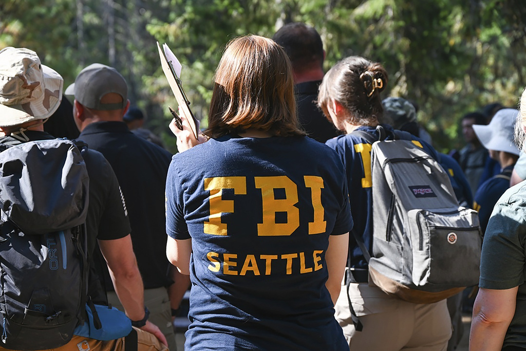 This photo provided by FBI Seattle shows FBI and other law enforcement agencies participating in the search for Travis Decker, who was charged with murder and kidnapping, at Rock Island Campground near Leavenworth, Wa. on Monday, August. 25, 2025. (FBI via AP)
