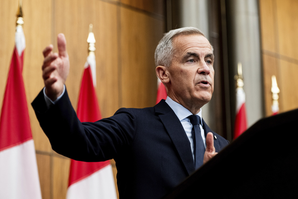 Prime Minister Mark Carney speaks during a news conference at the National Press Theatre in Ottawa on Friday, Aug. 22, 2025. (Spencer Colby/The Canadian Press via AP)