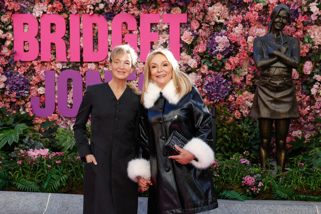 Renee Zellweger, left, and writer Helen Fielding pose for photographers during the unveiling of the Bridget Jones statue in Leicester Square, London, Monday, Nov. 17, 2025. (Photo by Millie Turner/Invision/AP)