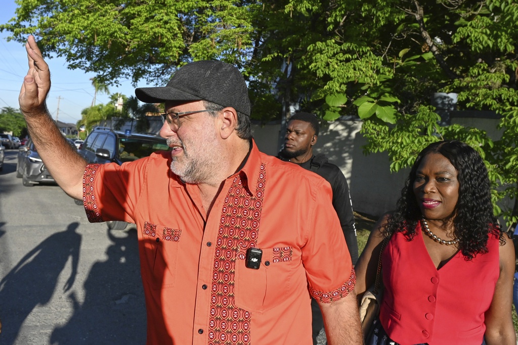 Mark Jefferson Golding, opposition leader and president of the People's National Party who is running for Prime Minister, waves as he heads to a polling station during general elections in Kingston, Jamaica, Wednesday, Sept. 3, 2025. (AP Photo/Collin Reid)