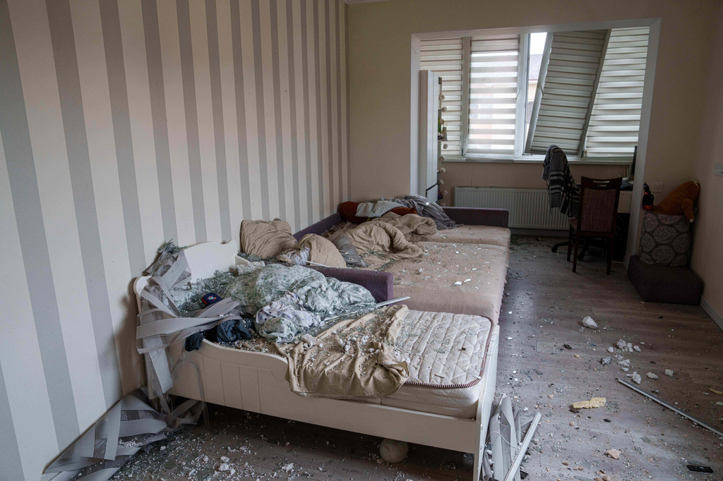 Broken glass is seen on beds at an which was damaged after a Russian strike on residential neighbourhood in Kriukivshchyna, Kyiv region, Ukraine, on Friday, April 3, 2026. (AP Photo/Evgeniy Maloletka)