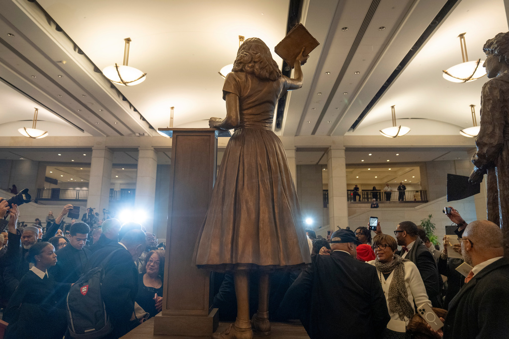 People take photos of a statue of Virginia civil rights activist Barbara Rose Johns, whose statue will replace one of Robert E. Lee as one of Virginia's two statues on display at the Capitol, at a dedication ceremony Tuesday, Dec. 16, 2025, in Washington. (AP Photo/Mark Schiefelbein)