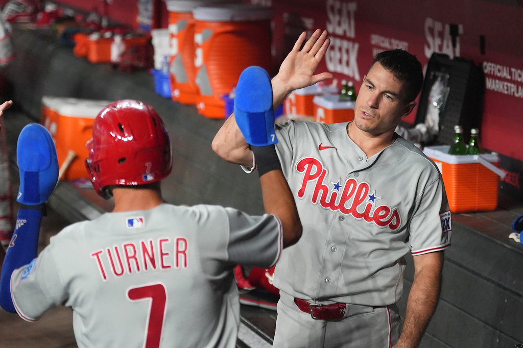 Philadelphia Phillies' Trea Turner (7) celebrates his run scored against the Arizona Diamondbacks with Phillies' J.T. Realmuto during the first inning of a baseball game, Tuesday, Sept. 1, 2026, in Phoenix. (AP Photo/Ross D. Franklin)