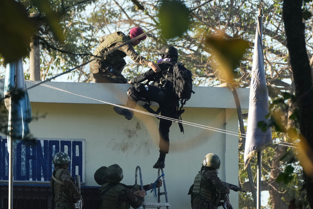 Security forces enter the Renovation maximum-security prison to free guards taken hostage and retake control of the facility, which houses gang leaders, in Escuintla, Guatemala, Sunday, Jan. 18, 2026. (AP Photo/Moises Castillo)