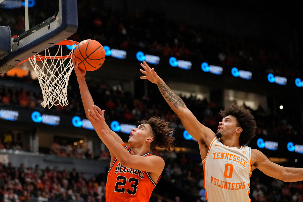 Illinois guard Keaton Wagler (23) shoots the ball past Tennessee guard Ja'Kobi Gillespie (0) during the first half of an NCAA college basketball game Saturday, Dec. 6, 2025, in Nashville, Tenn. (AP Photo/George Walker IV)