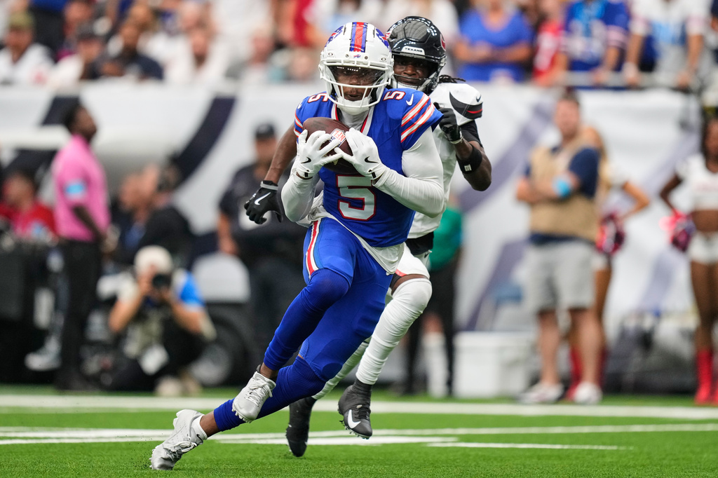Buffalo Bills wide receiver Joshua Palmer (5) runs the ball into the end zone for a touchdown past Houston Texans cornerback Kamari Lassiter, right, during the second half of an NFL football game, Sunday, Sept. 13, 2026, in Houston. (AP Photo/Ashley Landis)