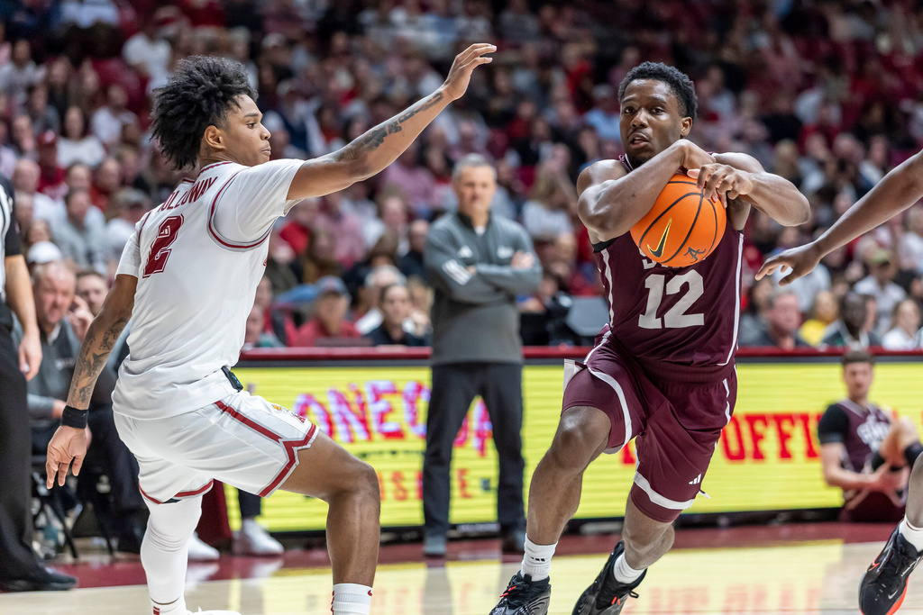 Mississippi State guard Josh Hubbard (12) works past Alabama guard Aden Holloway (2) during the second half of an NCAA college basketball game Wednesday, Feb. 25, 2026, in Tuscaloosa, Ala. (AP Photo/Vasha Hunt)