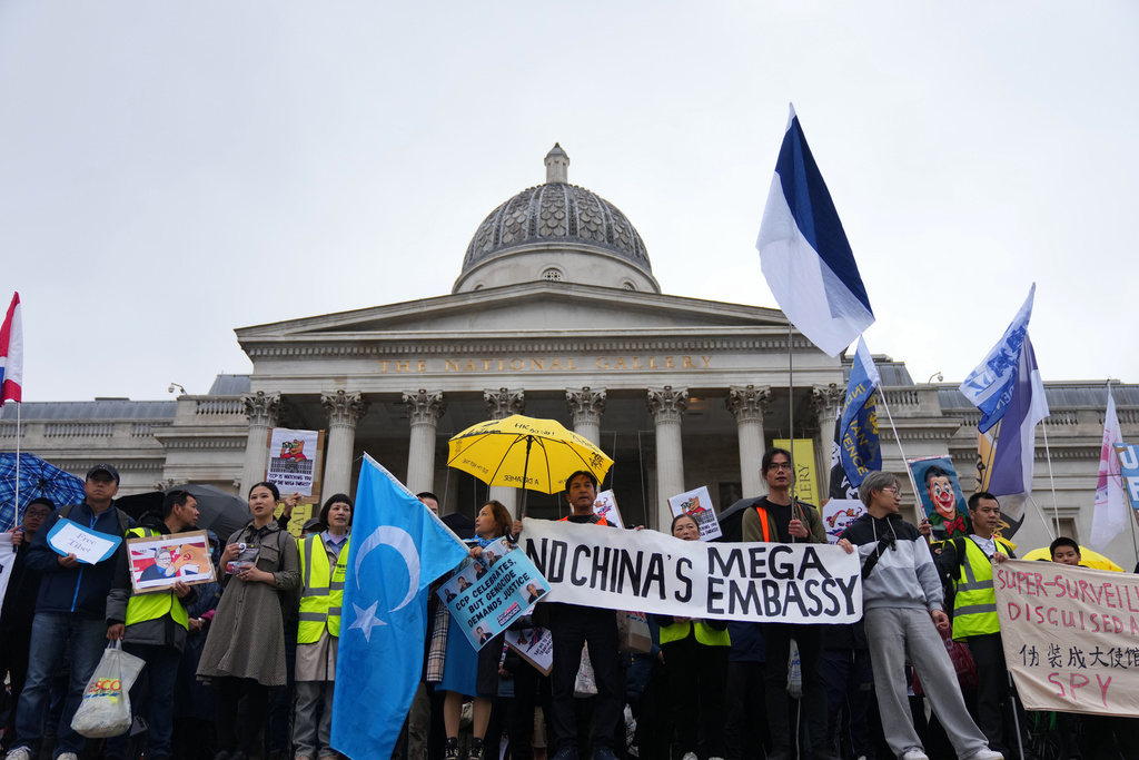 FILE - Protesters hold umbrellas, placards, and flags as they demonstrate against the proposed building of a new Chinese embassy, and to mark the 11th year of the Umbrella Revolution in Hong Kong, in London, Sunday, Sept. 28, 2025. (AP Photo/Joanna Chan, file)