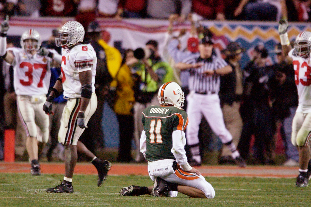 FILE - Miami quarterback Ken Dorsey, center, sits on the turf as Ohio State players celebrate their team's victory in the Fiesta Bowl in Tempe, Ariz., Jan. 3, 2003. (AP Photo/Mark J. Terrill, File)