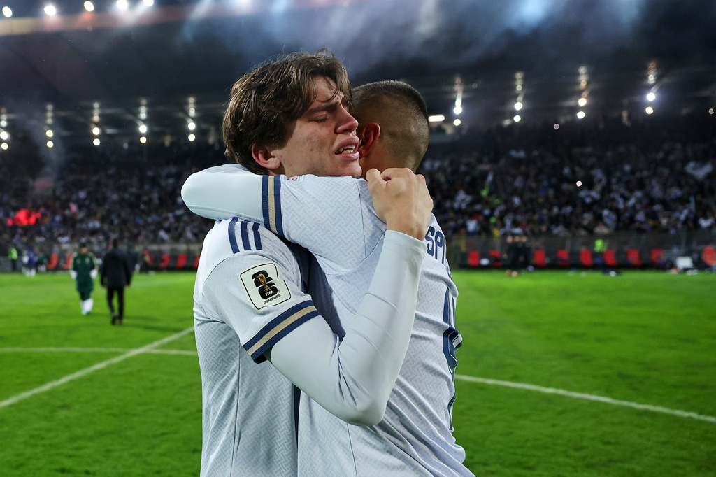 Italy's Marco Palestra, left, and Leonardo Spinazzola console each other after losing a penalty shootout during the World Cup qualifying playoff final soccer match between Bosnia and Italy in Zenica, Bosnia, Tuesday, March 31, 2026. (AP Photo/Armin Durgut)