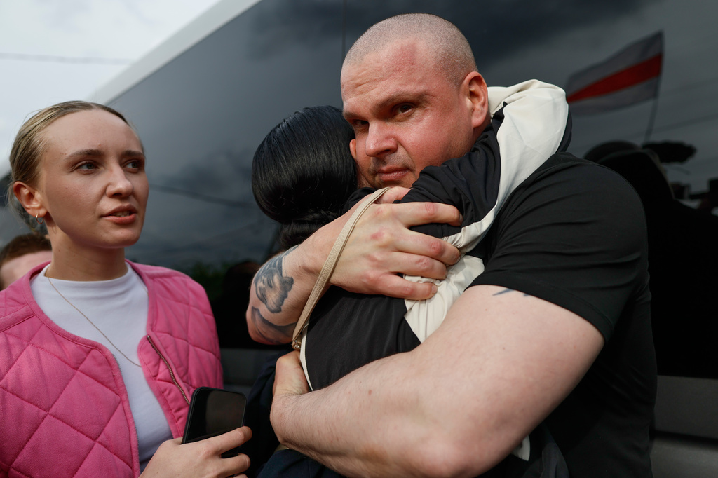 Dzmitryi Halavach, one of the released Belarusian prisoners, embraces his colleague as he arrives in Vilnius, Lithuania, Wednesday, Sept. 16, 2026. (AP Photo/Mindaugas Kulbis)