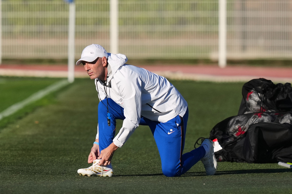 France national soccer team coach Zinedine Zidane ties his shoes during a training session in Clairefontaine-en-Yvelines west of Paris, Tuesday, Sept. 22, 2026, three days ahead of France's UEFA Nations League soccer match against Turkey. (AP Photo/Thibault Camus)