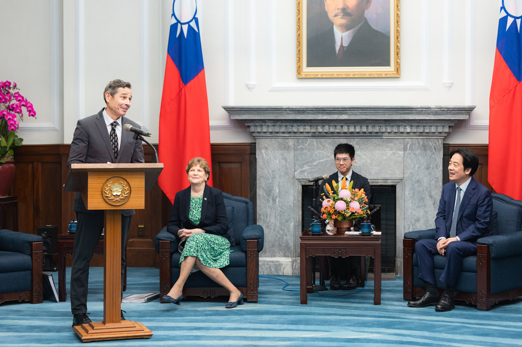 In this photo, released by the Taiwan Presidential Office, Taiwan's President William Lai Ching-te, right, listens to visiting U.S. lawmaker US Sen. John Curtis, left, while speaking next to Jeanne Shaheen, second from left, in Taipei, Taiwan, Monday, March 30, 2026. (Taiwan Presidential Office via AP)