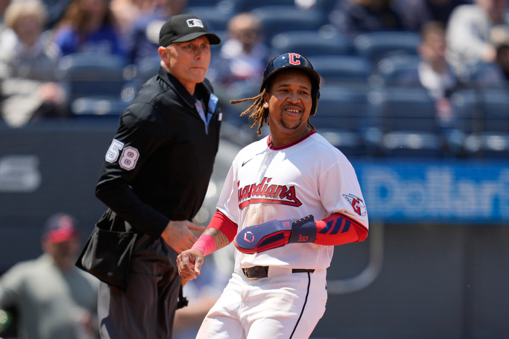 Cleveland Guardians' José Ramírez scores in front of home plate umpire Dan Iassogna (58) in the first inning of a baseball game against the Los Angeles Angels in Cleveland, Wednesday, May 13, 2026. (AP Photo/Sue Ogrocki)
