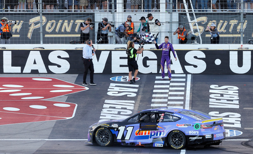 Denny Hamlin picks up the checkered flag after winning a NASCAR Cup Series auto race Sunday, Oct. 12, 2025, in Las Vegas. (AP Photo/Steve Marcus) Denny Hamlin picks up the checkered flag after winning a NASCAR Cup Series auto race Sunday, Oct. 12, 2025, in Las Vegas. (AP Photo/Steve Marcus)
