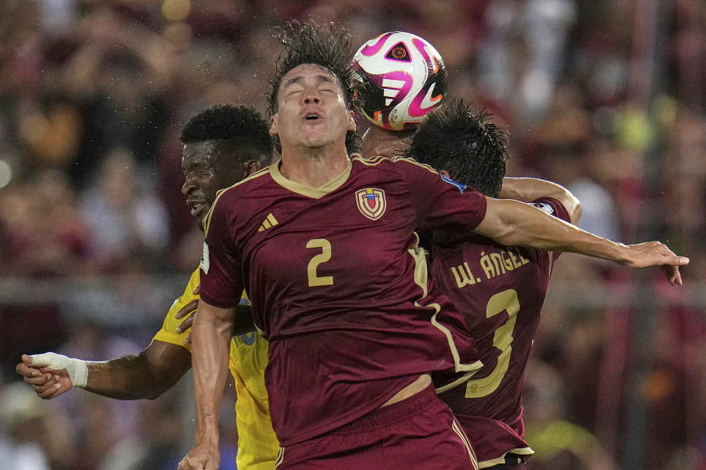 Venezuela's Nahuel Ferraresi heads the ball during a World Cup 2026 qualifying soccer match against Colombia in Maturin, Venezuela, Tuesday, Sept. 9, 2025. (AP Photo/Ariana Cubillos)