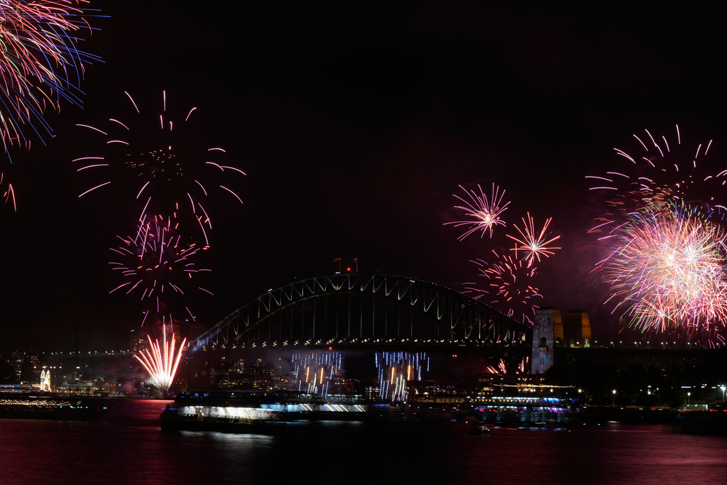 Fireworks burst over the Sydney Harbour Bridge as New Year's celebrations begin in Sydney, Wednesday, Dec. 31, 2025. (AP Photo/Rick Rycroft)