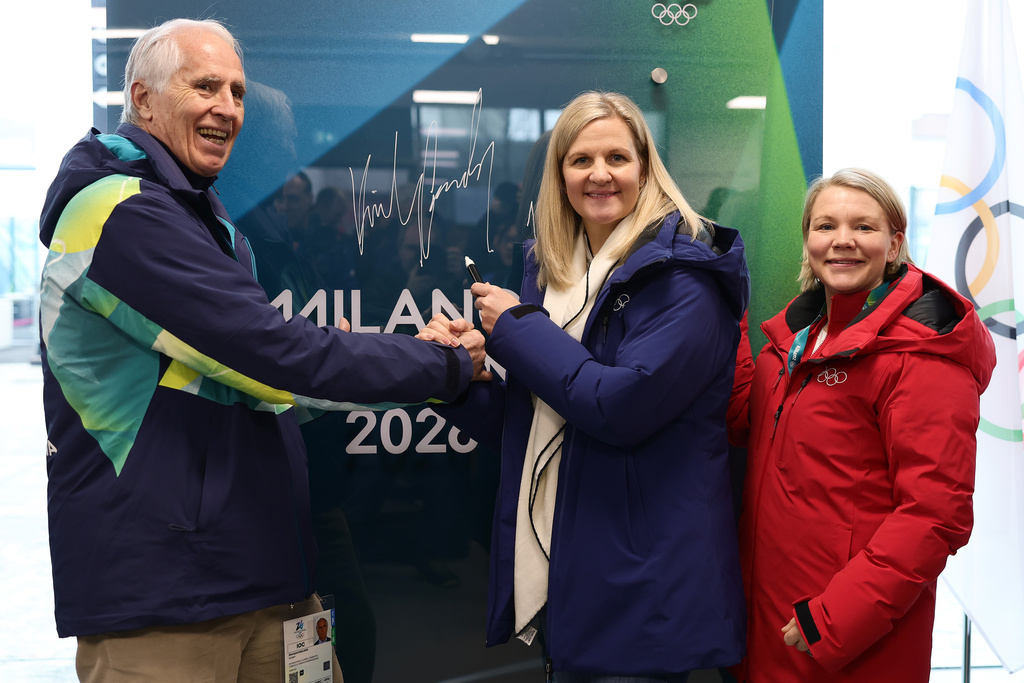 IOC President Kirsty Coventry, second right, poses for a photo with the President of the Milano Cortina Organising Committee Giovanni Malago, left and Chair of the IOC Athletes' Commission Emma Terho, during the inauguration of the Olympic Truce Mural, at the Olympic Village, ahead of the 2026 Winter Olympics, in Milan, Italy, Monday, Feb. 2, 2026. (Andreas Rentz/Pool Photo via AP)