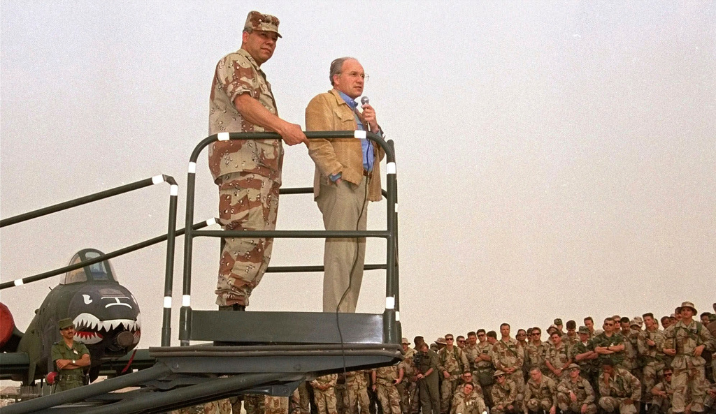 FILE - Secretary of Defense Dick Cheney, right, and Gen. Colin Powell, chairman of the Joint Chiefs of Staff, speak to members of the 354th Tactical Fighter Wing from Myrtle Beach, S.C. at their air base in Saudi Arabia, July 18, 1991. (AP Photo/Bob Daugherty, File)