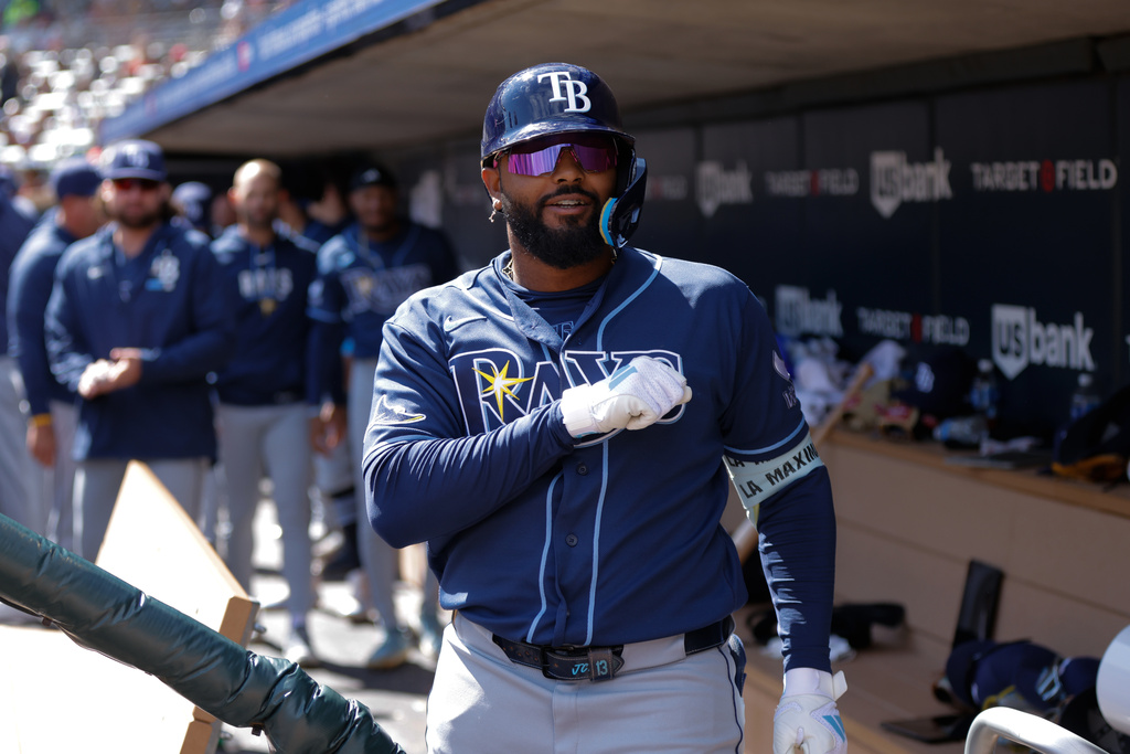 Tampa Bay Rays' Junior Caminero celebrates in the dugout after hitting a solo home run during the fourth inning of a baseball game against the Minnesota Twins, Sunday, April 5, 2026, in Minneapolis. (AP Photo/Bailey Hillesheim)