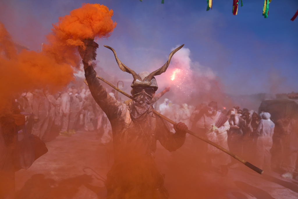 Revelers take part in the annual flour war marking the end of the Carnival season on Clean Monday in Galaxidi, about 200 kilometers (120 miles) west of Athens, Feb. 23, 2026, starting the 40-day Christian Lent fast leading to Easter. (AP Photo/Petros Giannakouris)