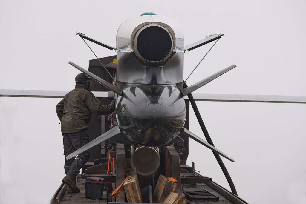 Workers and military inspect Ukrainian Fire Point's Flamingo missiles during handover to the military in an undisclosed location in Ukraine Thursday, Dec. 4, 2025. (AP Photo/Efrem Lukatsky)