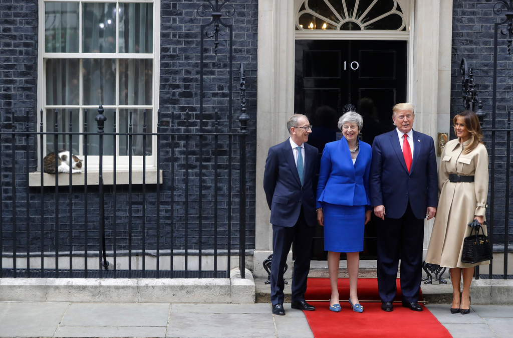 FILE - Britain's Prime Minister Theresa May and her husband Philip greet President Donald Trump and first lady Melania outside 10 Downing Street in central London, Tuesday, June 4, 2019. (AP Photo/Kirsty Wigglesworth, File)