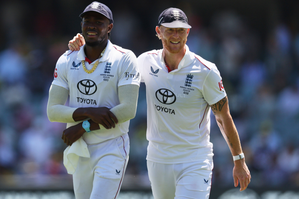 England's Ben Stokes, right, walks with teammate Jofra Archer after dismissing Australia during play on day four of the third Ashes cricket test between England and Australia in Adelaide, Australia, Saturday, Dec. 20, 2025. (AP Photo/James Elsby)