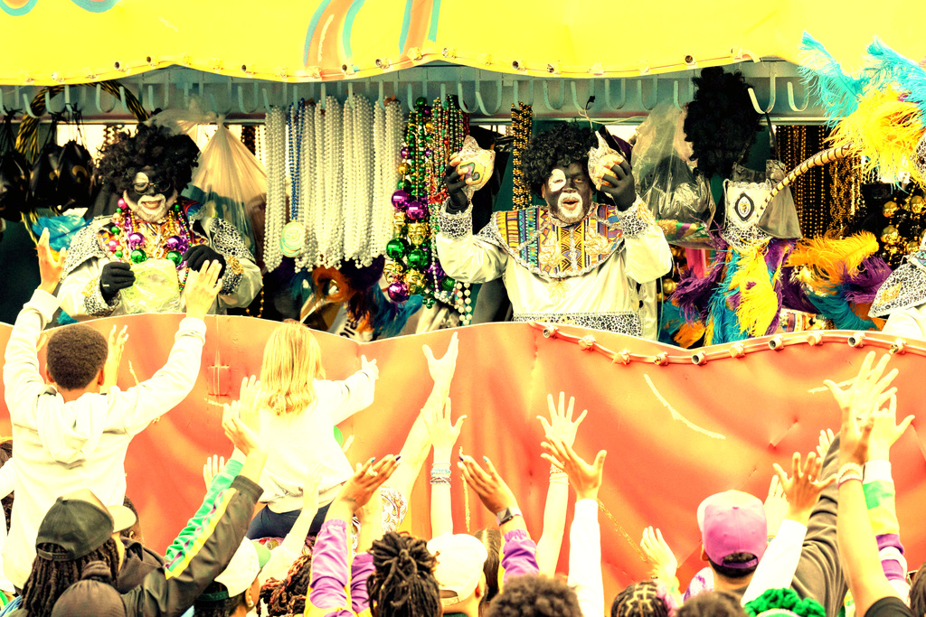 A member of the Krewe of Zulu offers up coconuts on Mardi Gras Day, Tuesday, Feb. 17, 2026 in New Orleans. (AP Photo/Matthew Hinton)