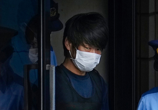 FILE - Tetsuya Yamagami, the alleged assassin of Japan's former Prime Minister Shinzo Abe, gets out of a police station in Nara, western Japan, on July 10, 2022, on his way to local prosecutors' office. (Nobuki Ito/Kyodo News via AP, File) FILE - Tetsuya Yamagami, the alleged assassin of Japan's former Prime Minister Shinzo Abe, gets out of a police station in Nara, western Japan, on July 10, 2022, on his way to local prosecutors' office. (Nobuki Ito/Kyodo News via AP, File)