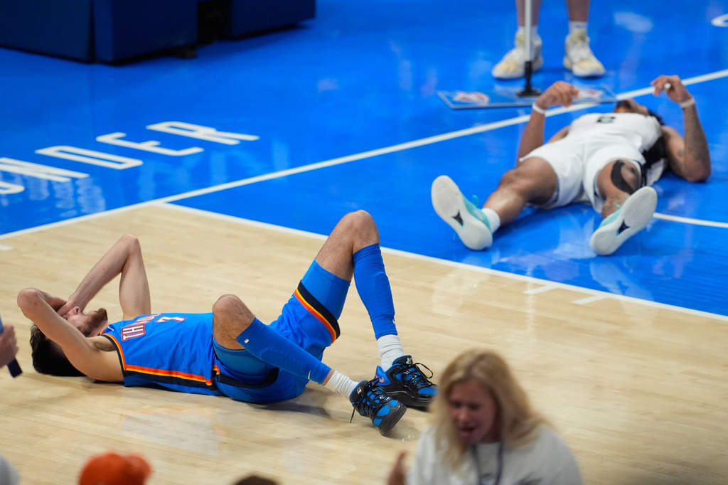Oklahoma City Thunder center Chet Holmgren (7) and San Antonio Spurs guard Dylan Harper (2) react after a foul call during the second half of Game 2 in the Western Conference finals NBA basketball playoffs series Wednesday, May 20, 2026, in Oklahoma City. (AP Photo/Tony Gutierrez)