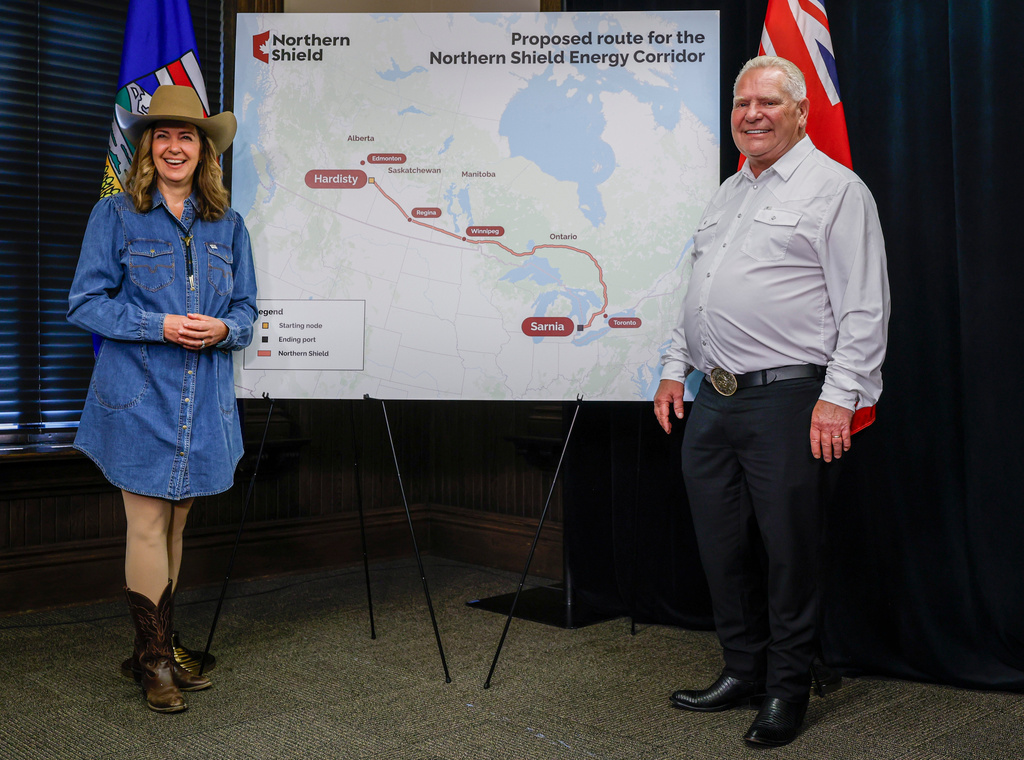Alberta Premier Danielle Smith, left, and Ontario Premier Doug Ford pose with a map of the Northern Shield pipeline proposal in Calgary, Canada, Monday, July 6, 2026. (Jeff McIntosh/The Canadian Press via AP)