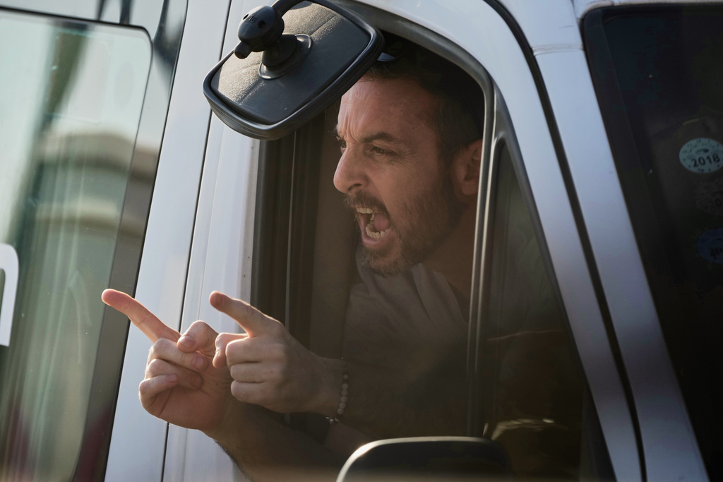 David Cunio, an Israeli hostage released from the Gaza Strip gestures from a minibus at the Sheba Medical Center in Ramat Gan, Israel, Monday, Oct. 13, 2025. (AP Photo/Leo Correa)