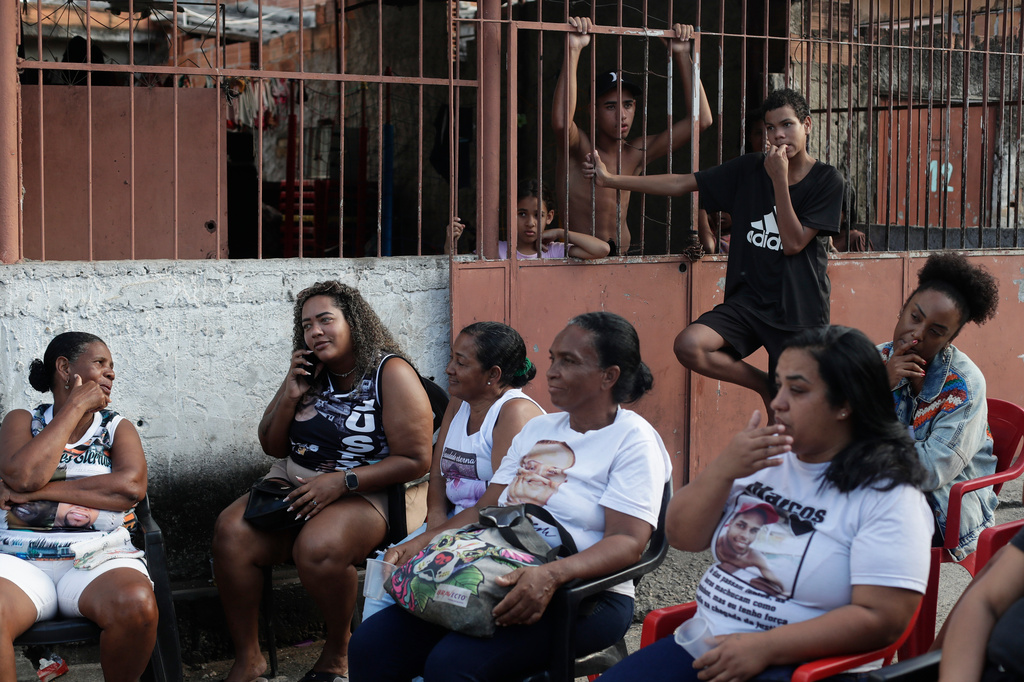 Mothers whose sons were killed by police attend a tribute event in the Morro da Crianca favela in Rio de Janeiro, Saturday, Sept. 19, 2026. (AP Photo/Bruna Prado)