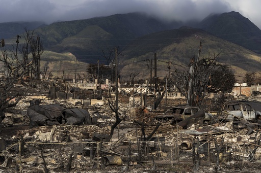 FILE - Damaged property lies scattered in the aftermath of a wildfire in Lahaina, Hawaii, Aug. 21, 2023. Officials on the Hawaiian island of Maui plan to send debris and ash from the August wildfire that destroyed Lahaina town to the island's central landfill. Local officials in Hawaii plan to open an office in April 2024, that will speed up Maui County's notoriously slow processing of building permits to help the town of Lahaina to recover from last year's deadly wildfire. Keanu Lau Hee, the county&rsquo;s deputy managing director, told a community meeting in Lahaina that a County Expedited Permitting Center will open in April.(AP Photo/Jae C. Hong, File)