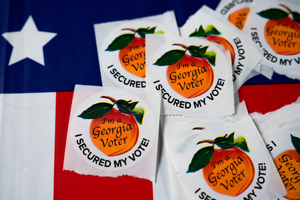 FILE - Stickers sit on a table inside a polling place, Nov. 5, 2024, in Atlanta. (AP Photo/Brynn Anderson, File)