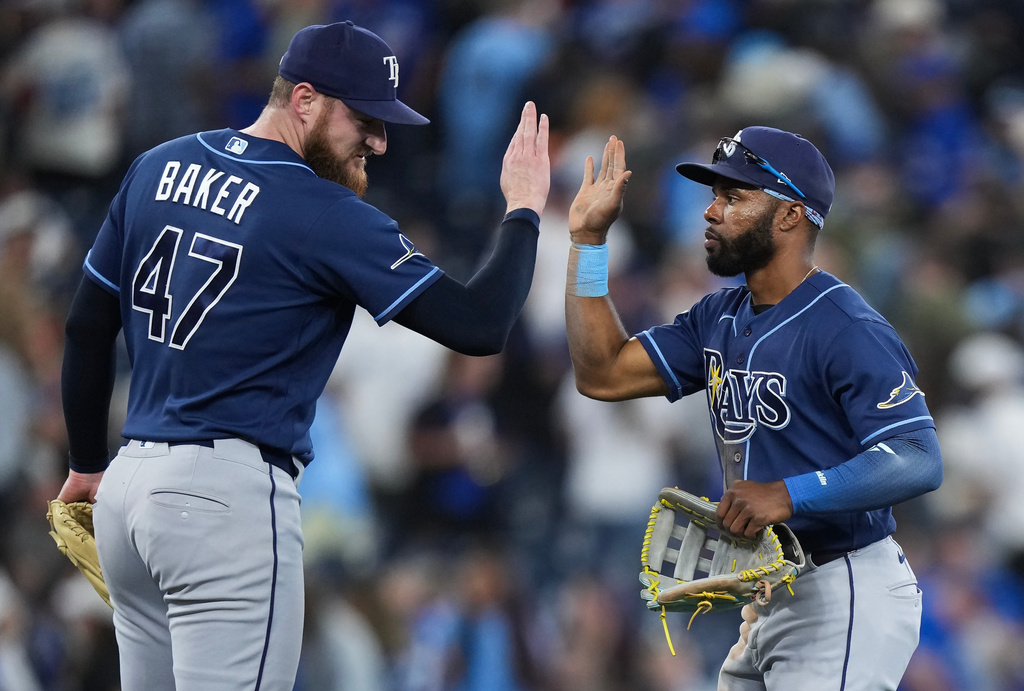 Tampa Bay Rays outfielder Cedric Mullins, right, celebrates with Bryan Baker (47) after defeating the Toronto Blue Jays in a baseball game in Toronto on Wednesday, July 22, 2026. (Nathan Denette/The Canadian Press via AP)